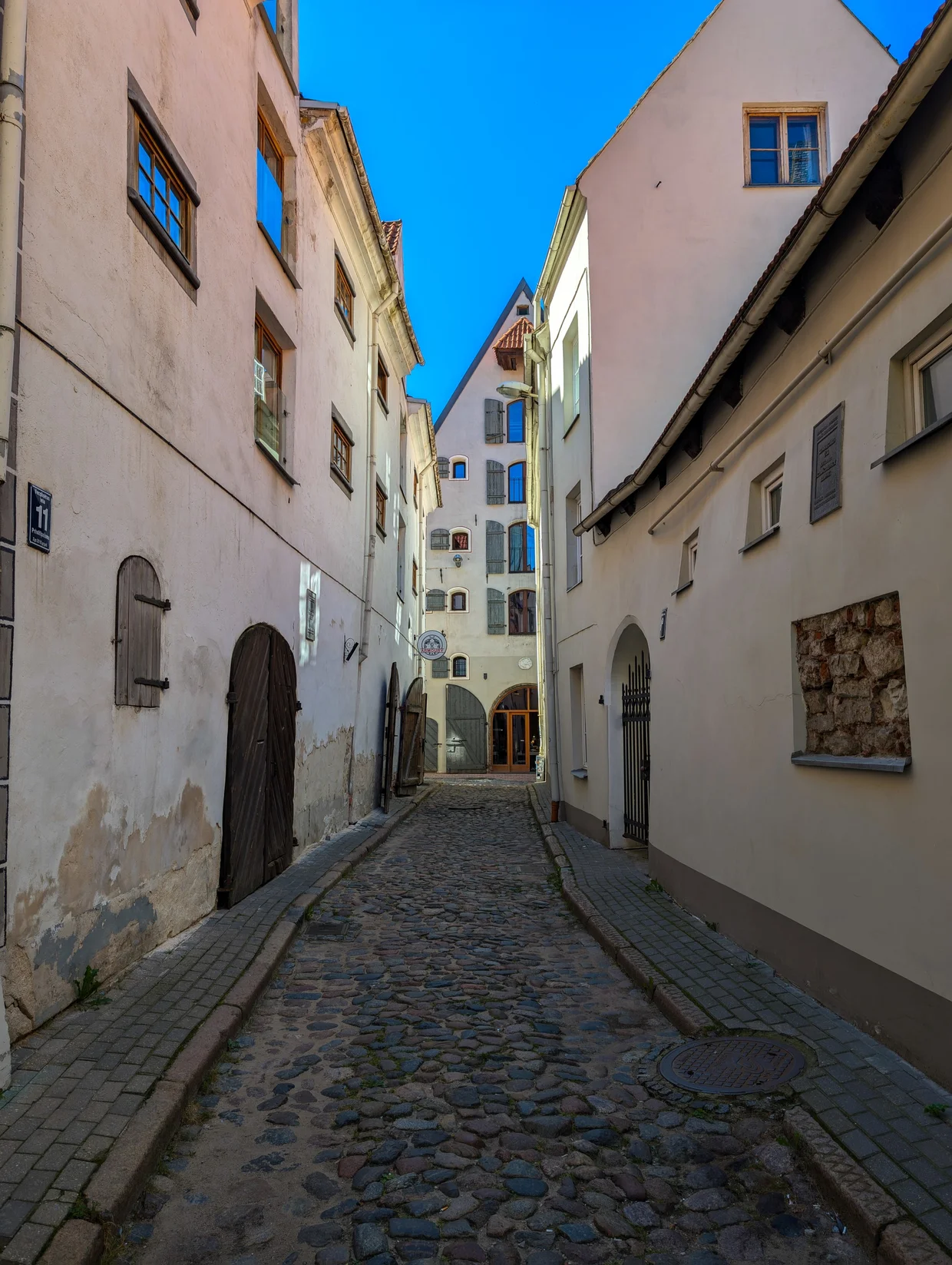 Cobblestone lane in Riga's Old Town, all honey-colored facades