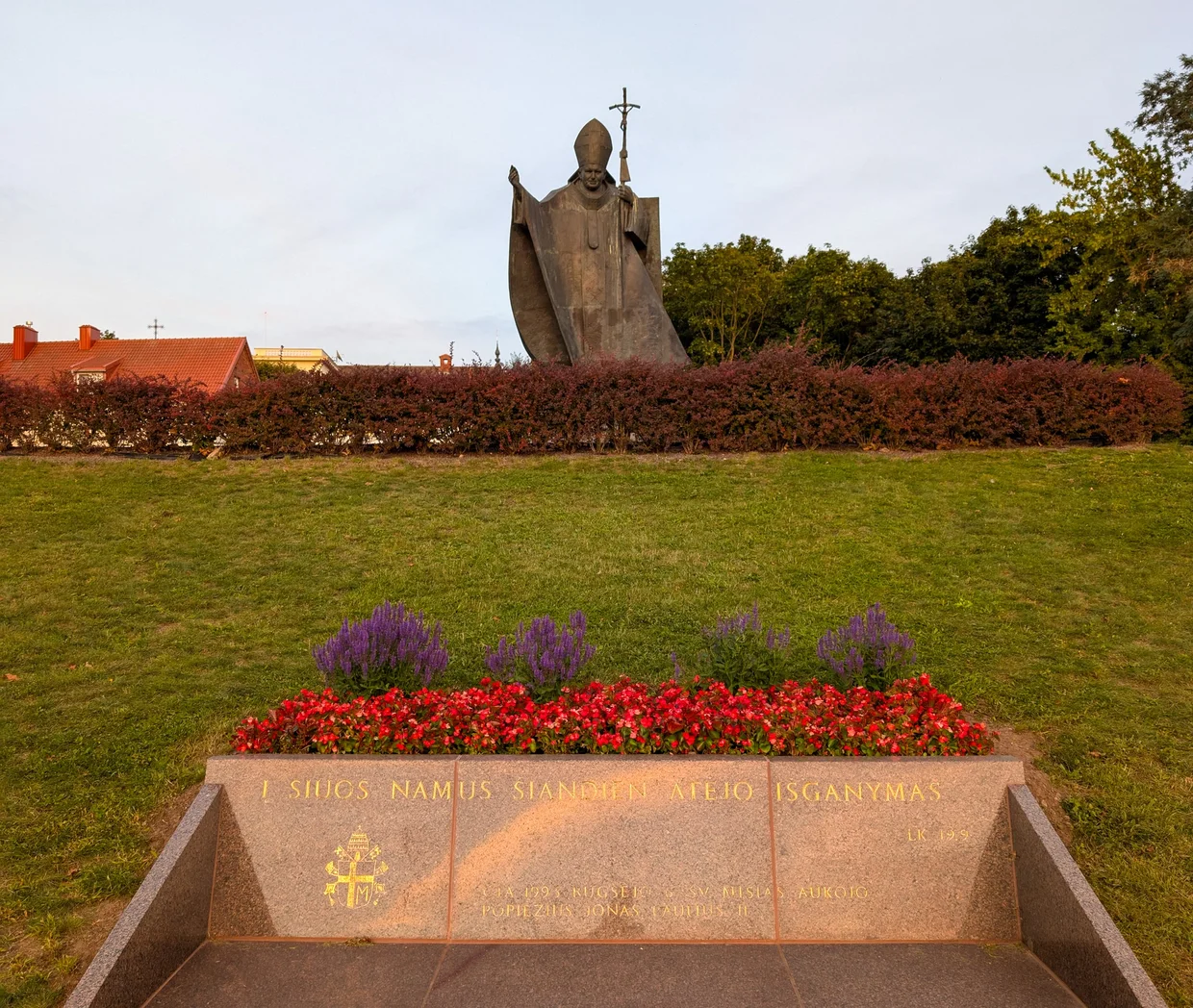 Statue of Pope John Paul II with flowers in front