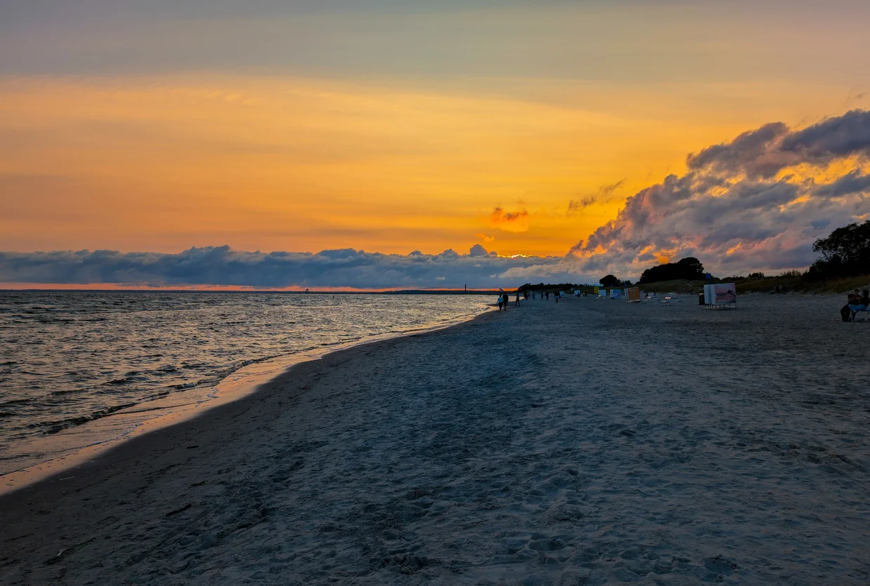 Orange sunset over Pärnu Beach with the wide sand stretching into the distance