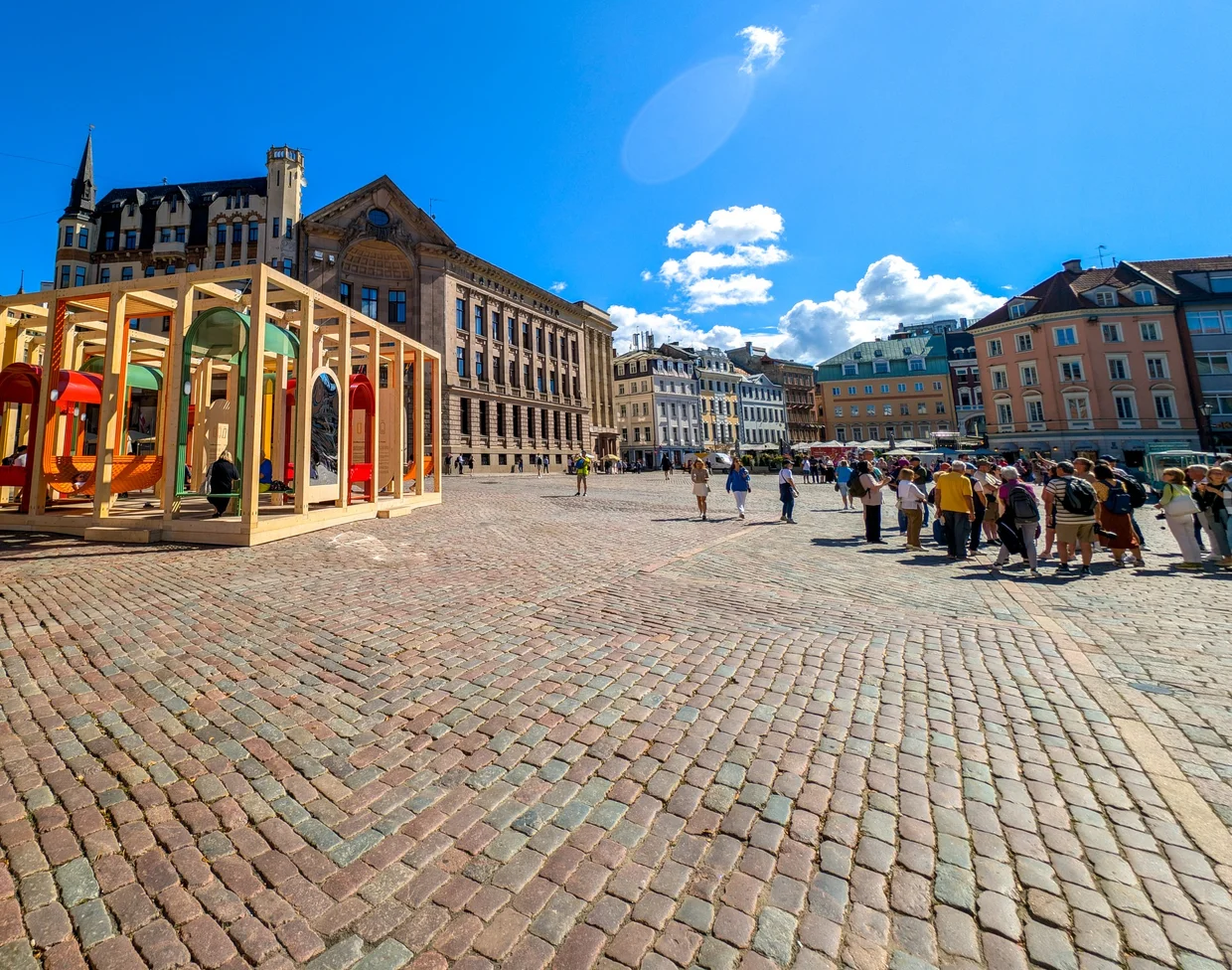A wooden pavilion installation on Dome Square with summer crowds