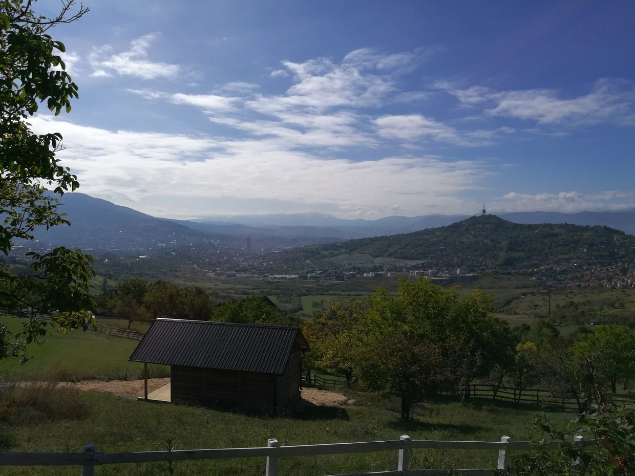 View across the Sarajevo valley from the surrounding hills, a wooden shed in the foreground