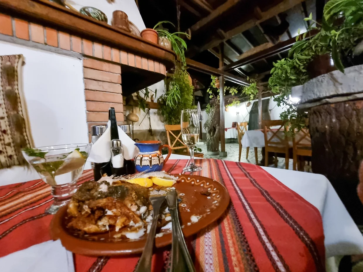 Traditional Bulgarian dinner at a restaurant with a woven tablecloth