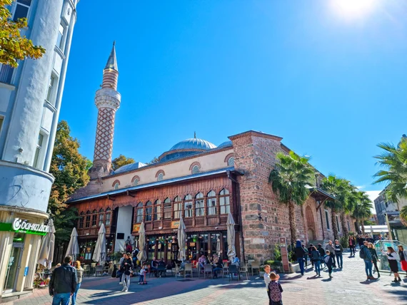 The mosque area with outdoor cafes and pedestrians
