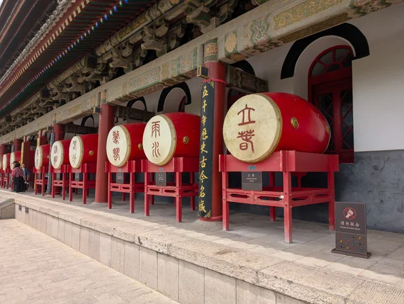 Row of large red ceremonial drums with Chinese characters inside the Xi'an Drum Tower