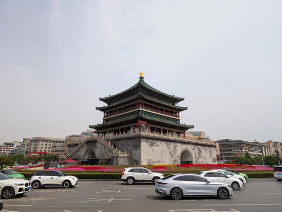 Xi'an Bell Tower with traditional tiered roof surrounded by modern traffic