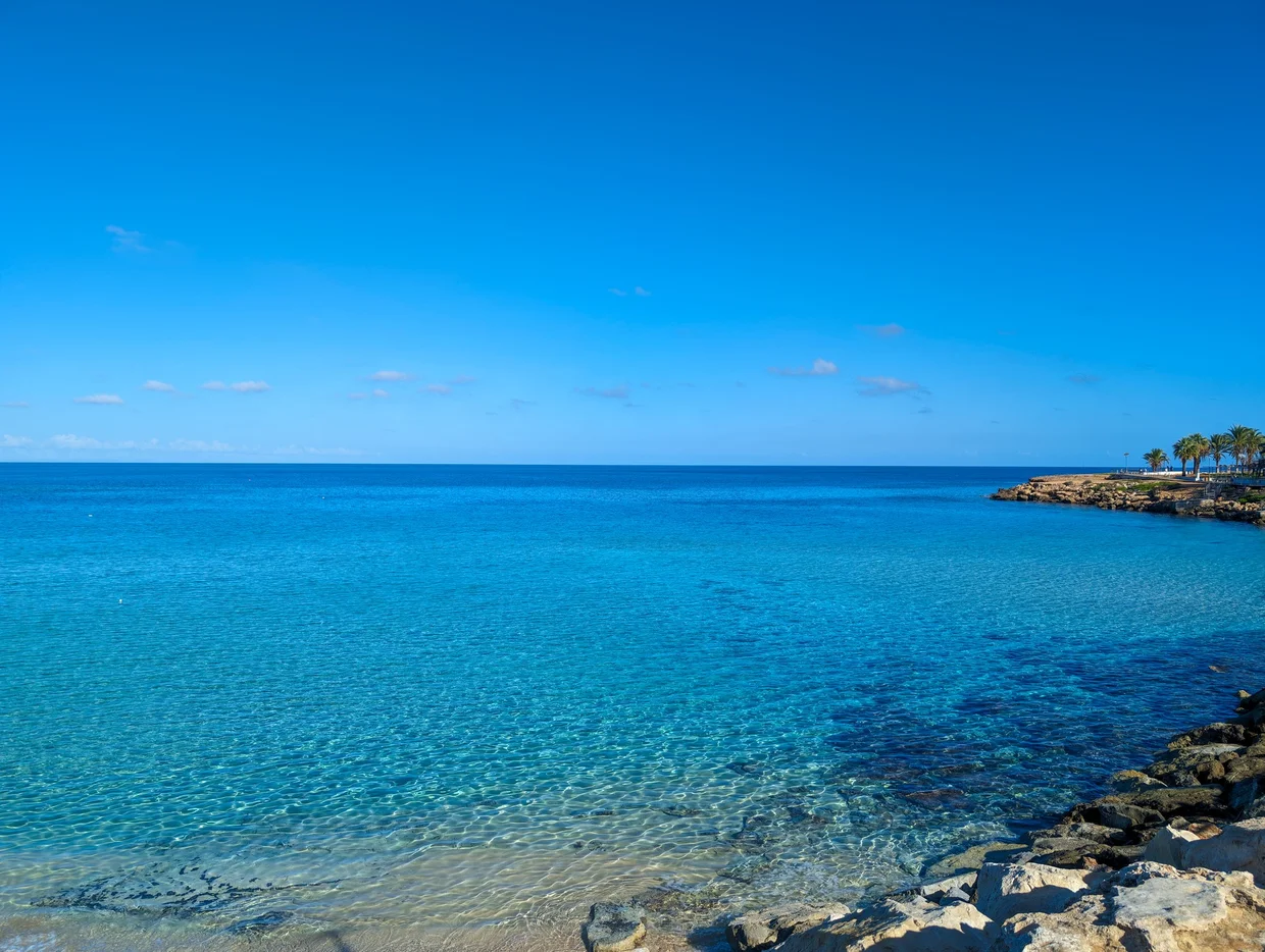 Crystal-clear turquoise water viewed from a rocky shoreline