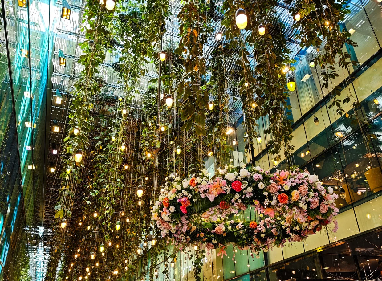 Detail of the Fünf Höfe hanging garden with floral arrangement and lights