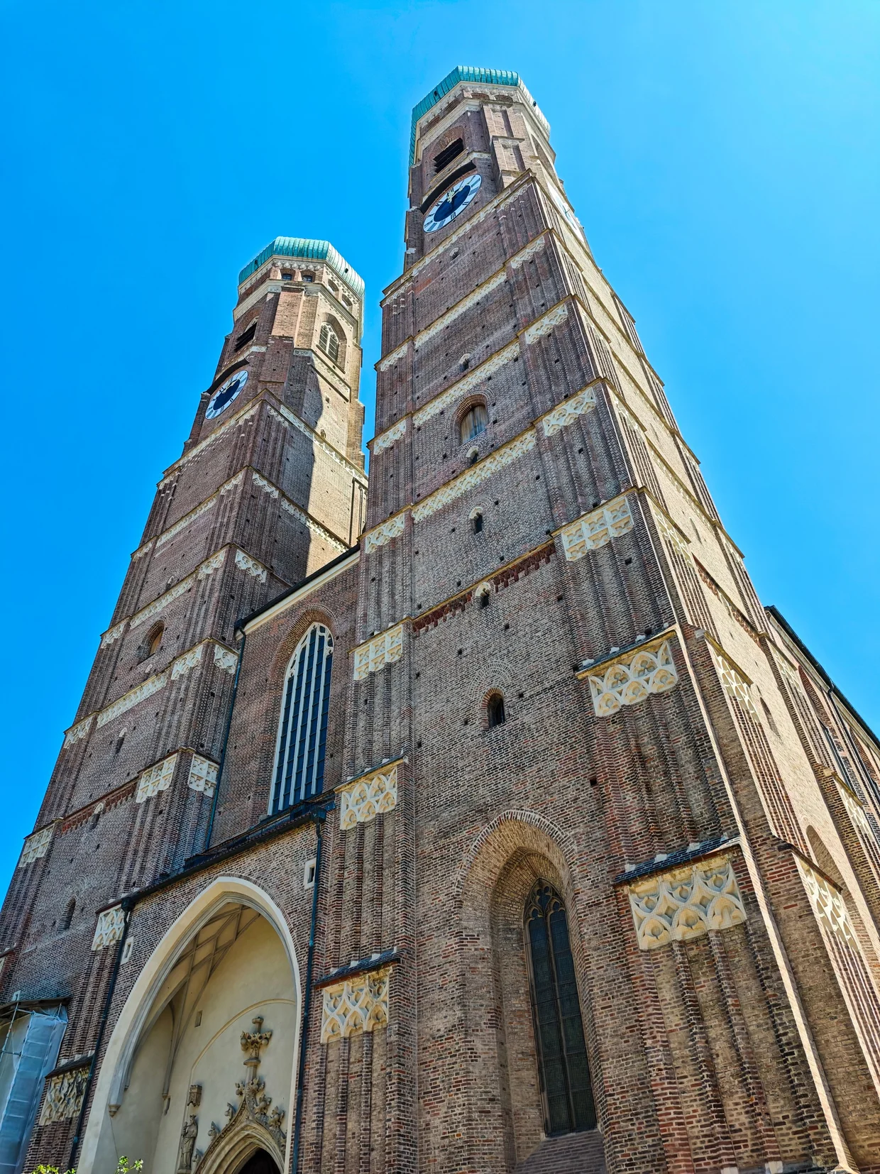 Looking up at the two brick towers of the Frauenkirche from below