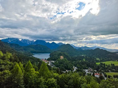 A wide evening panorama over the Alpsee, Hohenschwangau and the mountains