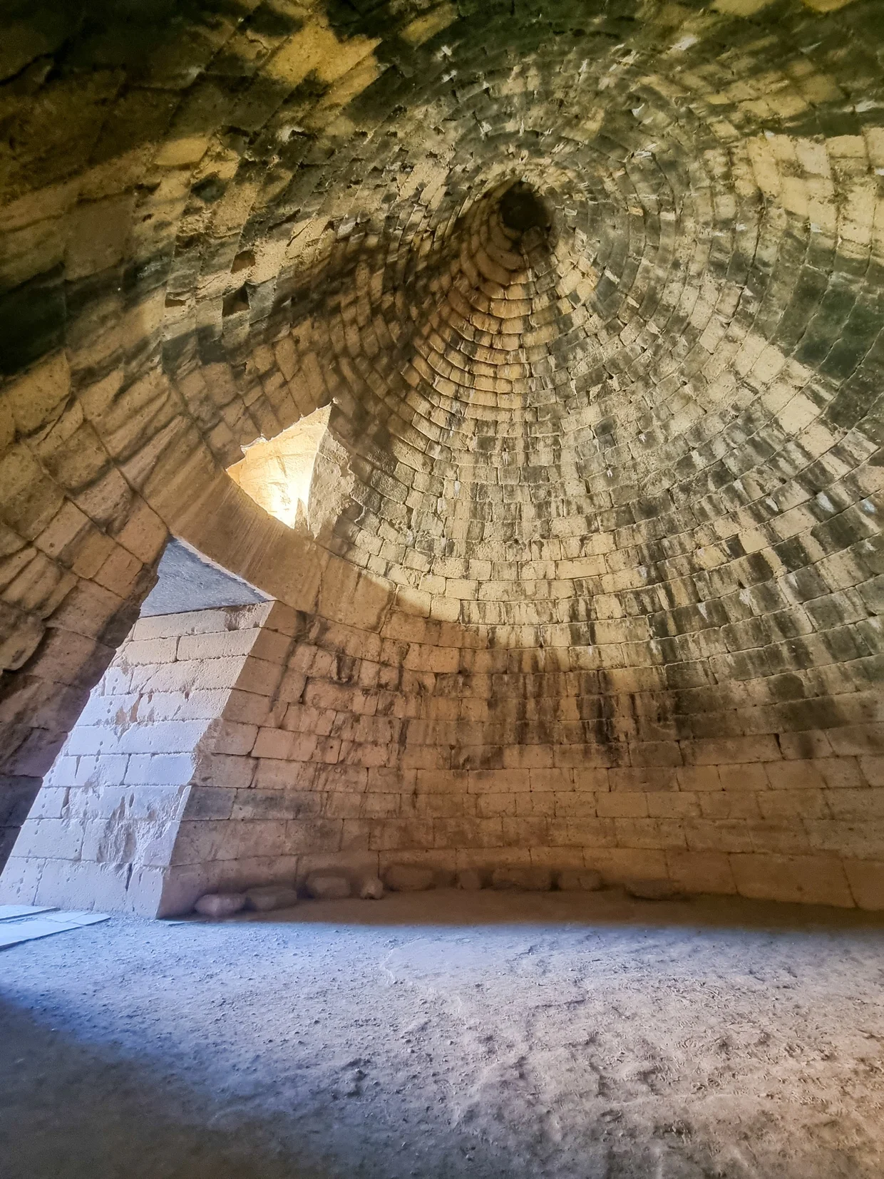 Interior of the Treasury of Atreus, a beehive stone dome curving upward
