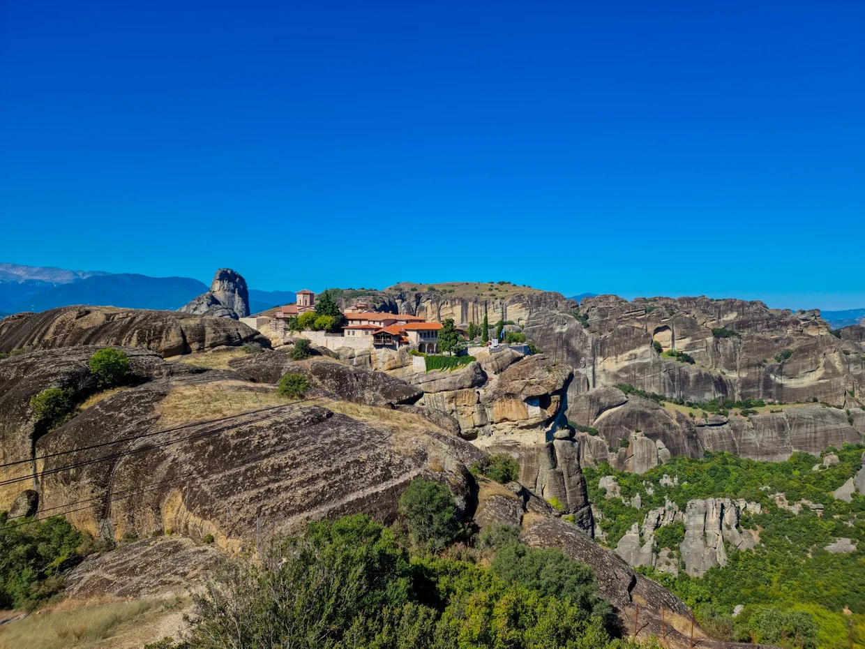 Byzantine monastery complex on flat-topped rocks above terraced slopes