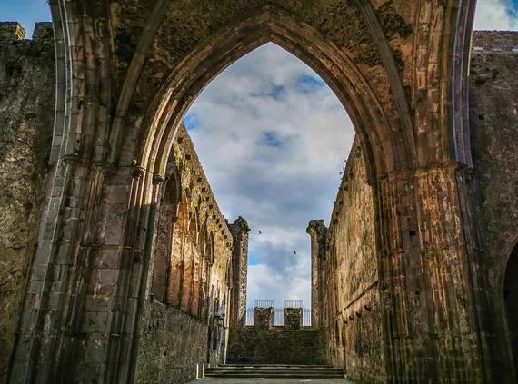 Gothic pointed arch framing the cathedral interior open to the sky