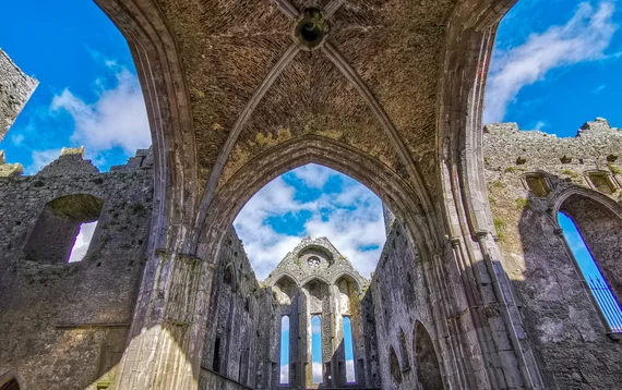 Ribbed vaulting and ornate arches inside the roofless cathedral