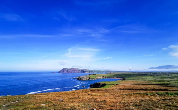Dingle Peninsula coastline with green fields and sea cliffs