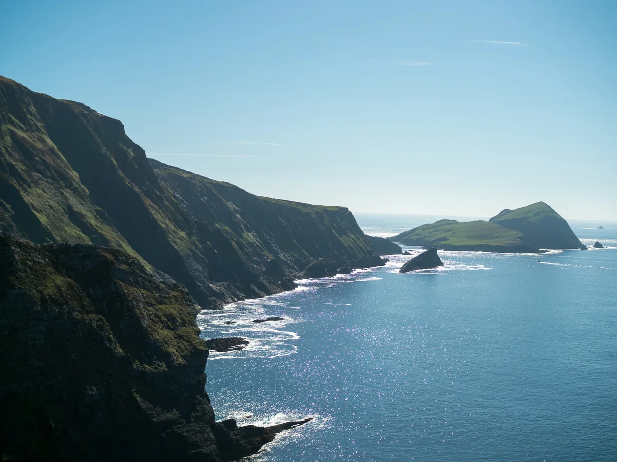 Kerry Cliffs dropping sheer into the Atlantic, headlands fading into haze