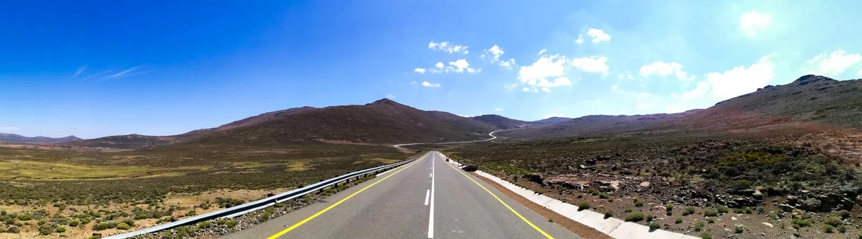 Paved road stretching through Lesotho's highland plateau