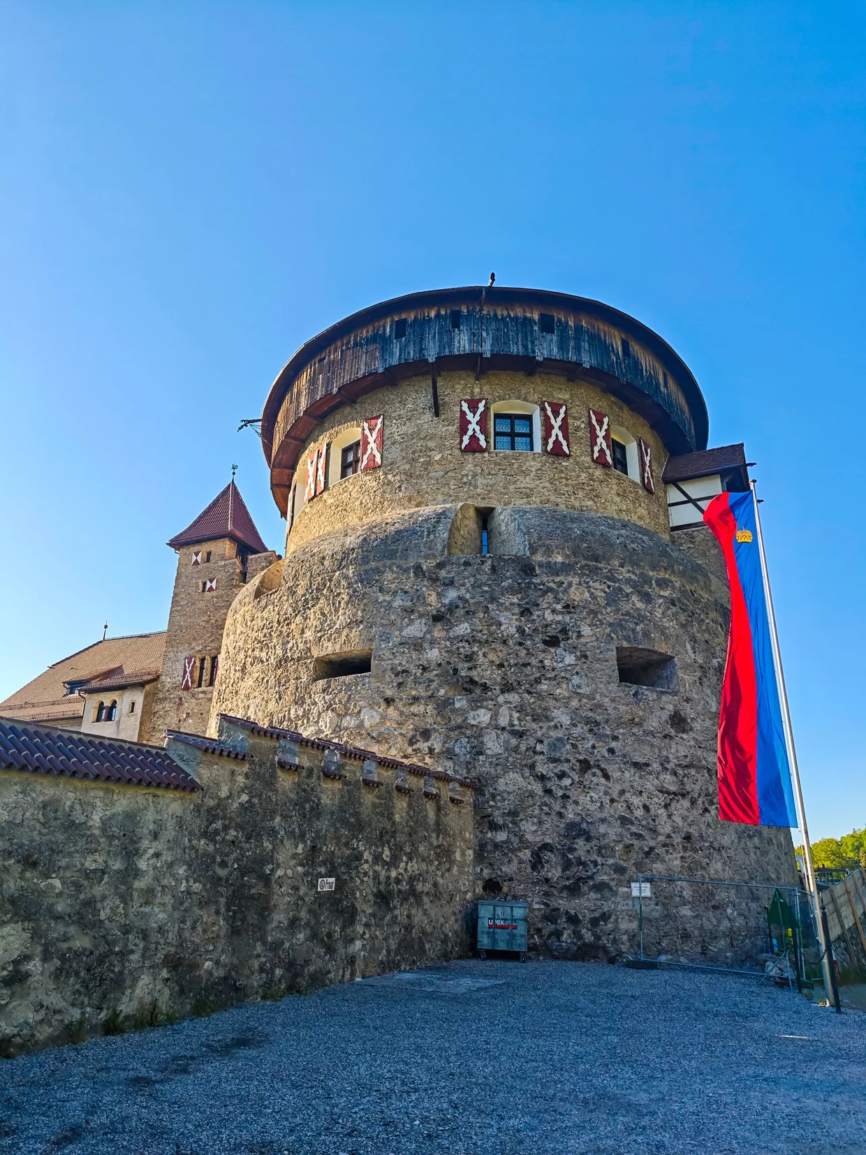 Vaduz Castle's round tower with the Liechtenstein flag
