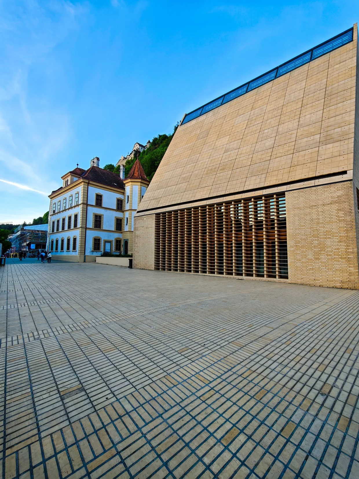 Modern parliament block in wood with the older yellow building beside it