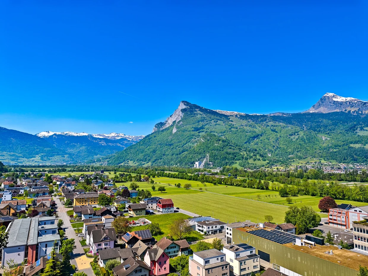 View over the Balzers rooftops, with the church and snow on the peaks