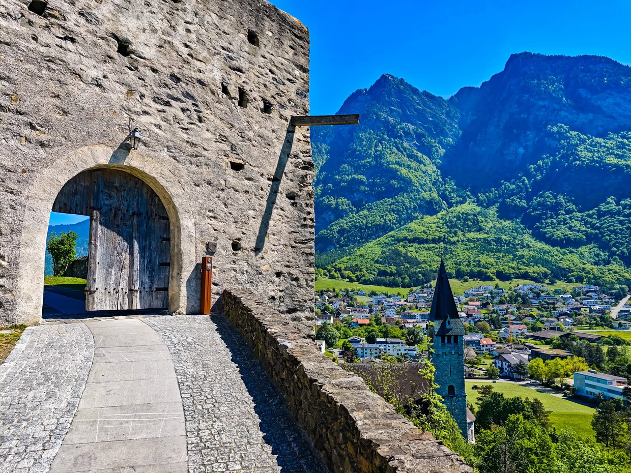 Gate from the inside looking out at the Balzers village and mountains beyond