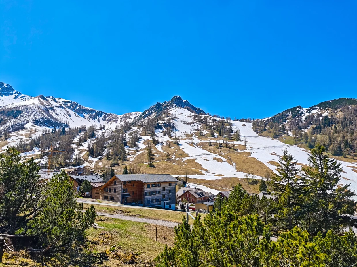 Malbun village with chalets and the snow line still visible up the slope