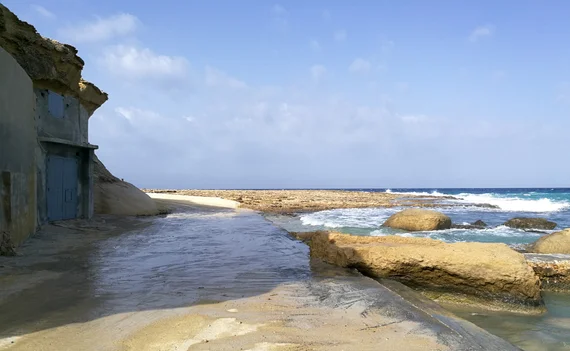 Rocky coast with a fisherman's boathouse built into the cliff