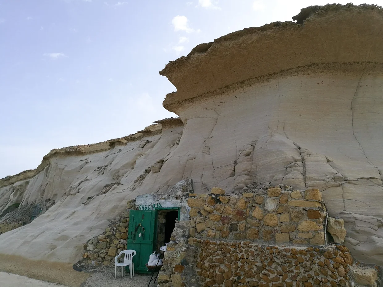 Dwelling built into a dramatic overhanging cliff face