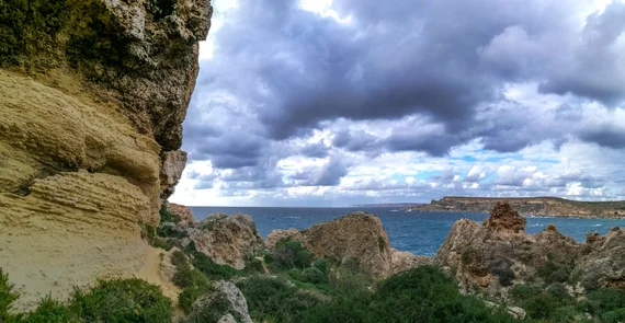 Rocky coastal landscape with weathered limestone boulders