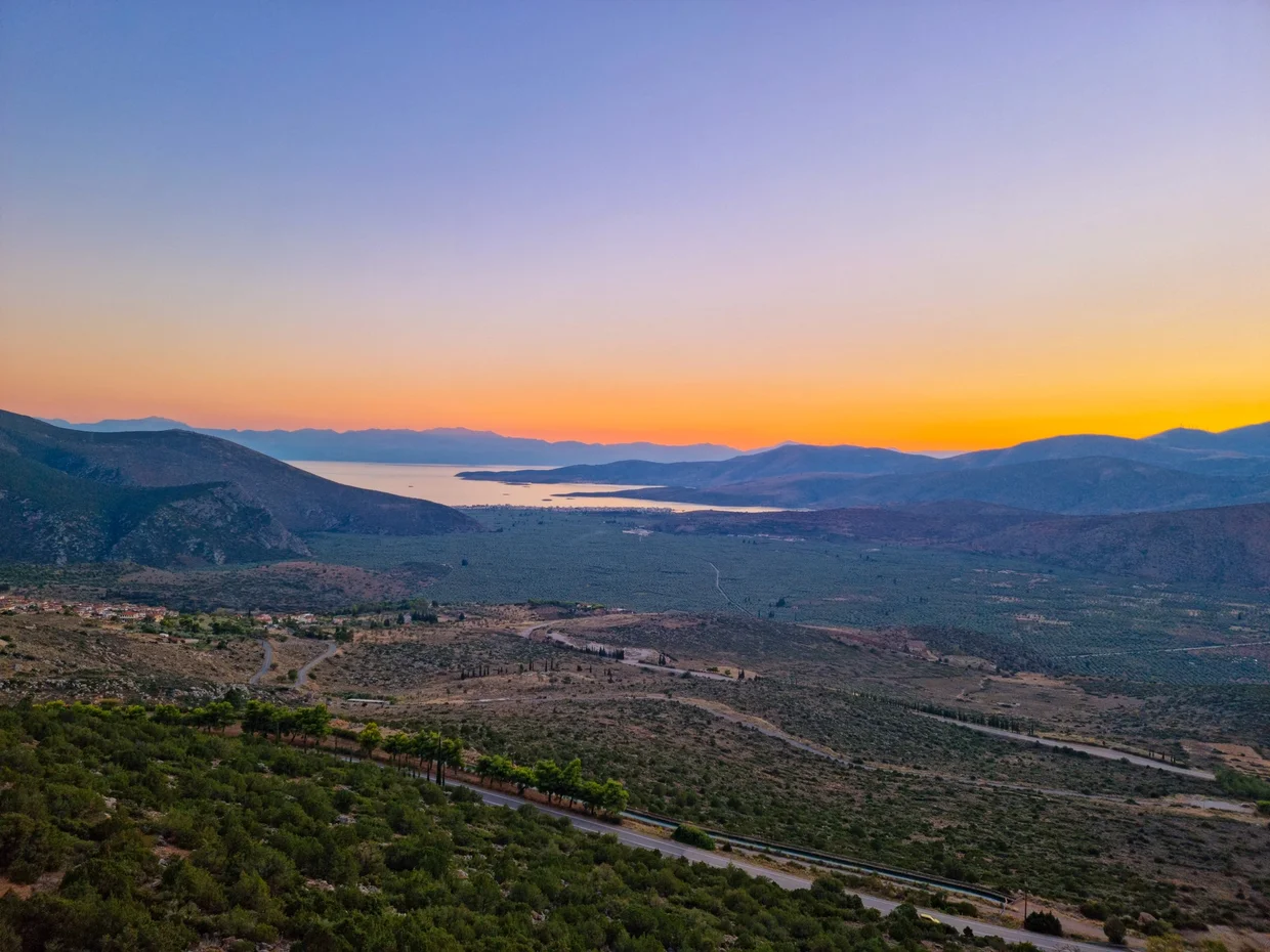 Golden sunset over the valley below Delphi toward the Gulf of Corinth