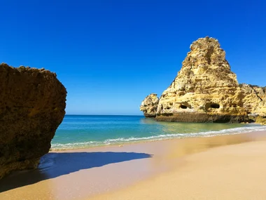 Golden rock formations on the beach