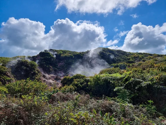Fumaroles steaming on the hillside