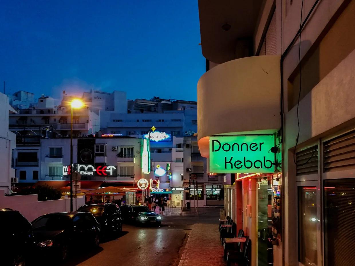 Albufeira's strip at night: neon bars, kebab shops, and not much Portugal