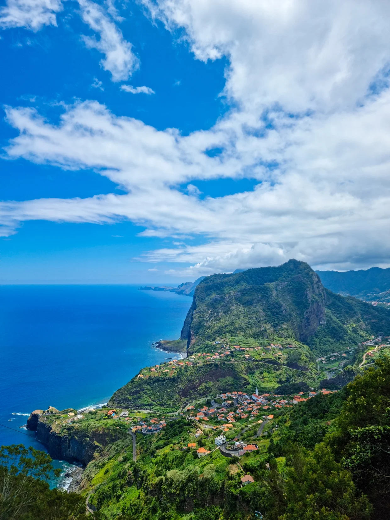 Panoramic view of Faial with Penha de Águia towering over the coastal village