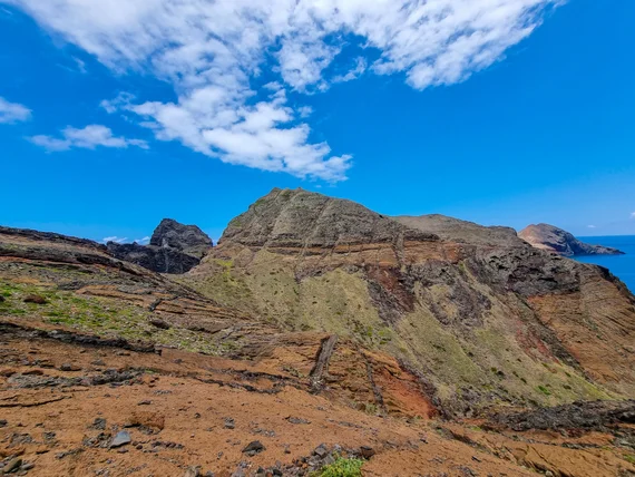 Layered volcanic rock formations, arid and wind-sculpted terrain
