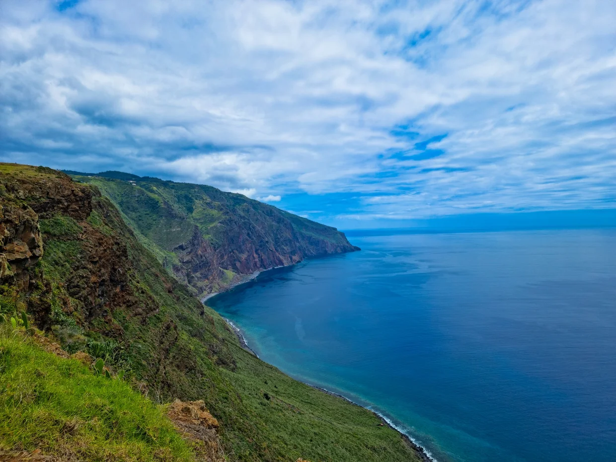 Dramatic green coastal cliffs dropping into the deep blue Atlantic