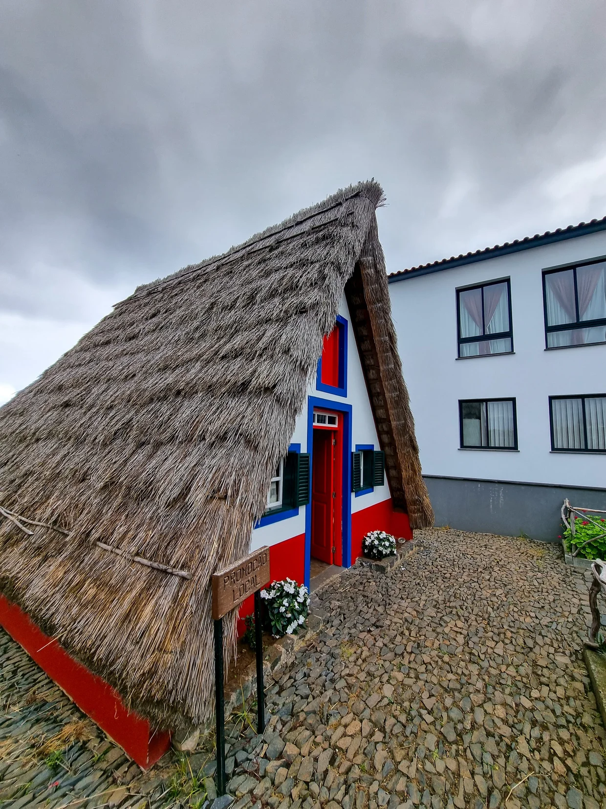 Traditional Santana thatched A-frame house with red and blue paint
