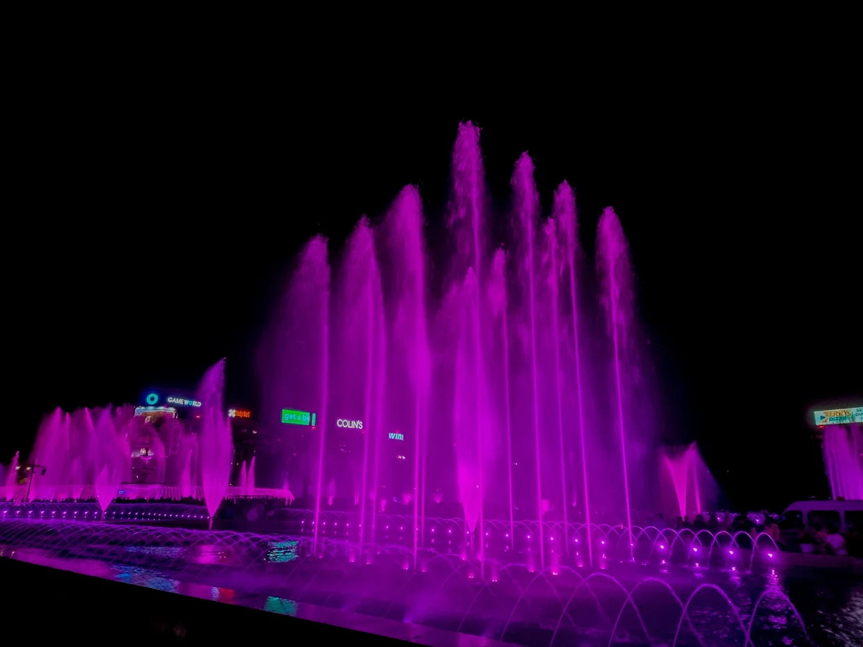Unirii fountains at night in purple drama mode