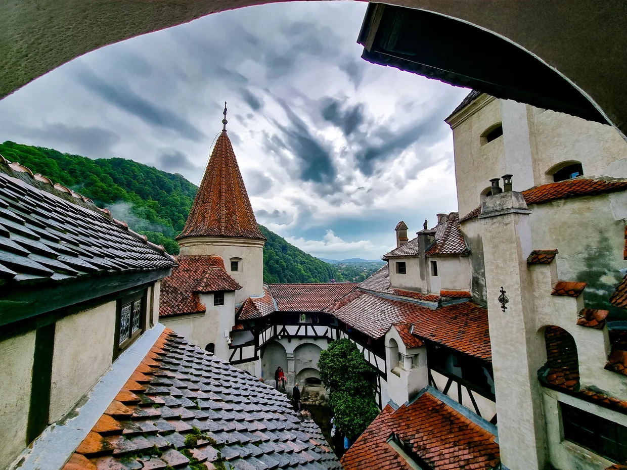 Bran Castle roofs and towers under extremely committed clouds