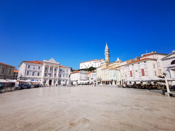 Wide empty view across Tartini Square with the bell tower