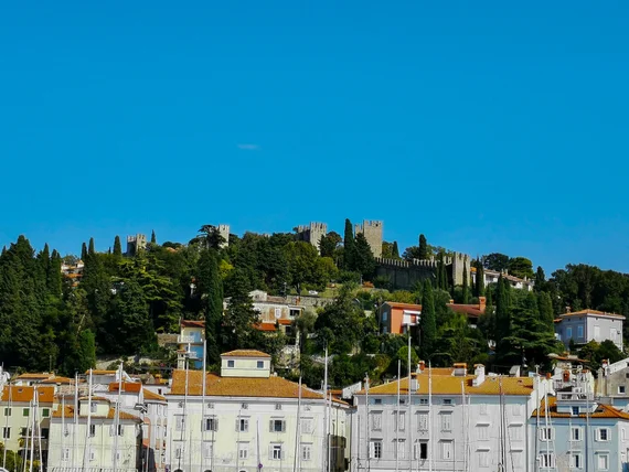Coastal hill with church walls above the town