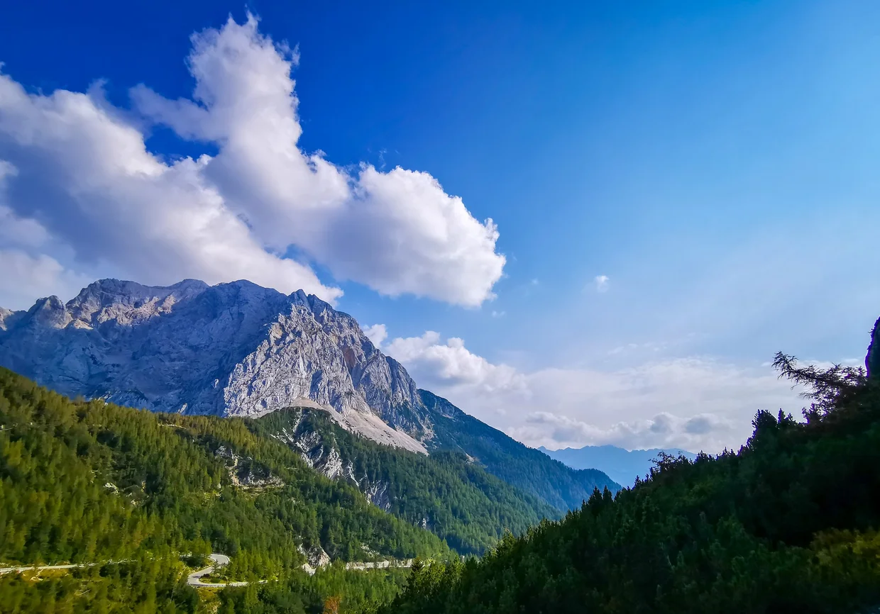 Single prominent alpine peak with valley below