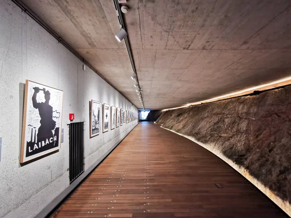Long exhibition corridor cut into rock inside the castle