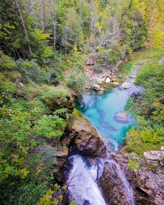 Overhead view of a turquoise waterfall in the forest