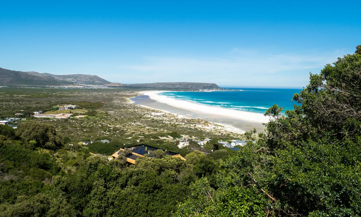 Sweeping view of Noordhoek Beach, a long white sand beach backed by fynbos