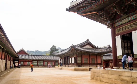 Spacious palace courtyard with traditional buildings and curved roofs