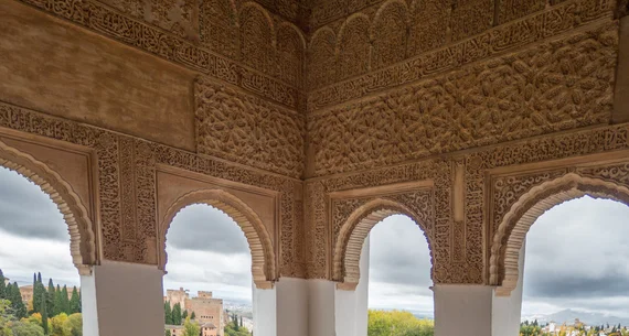 Carved archway framing a view of the Alhambra