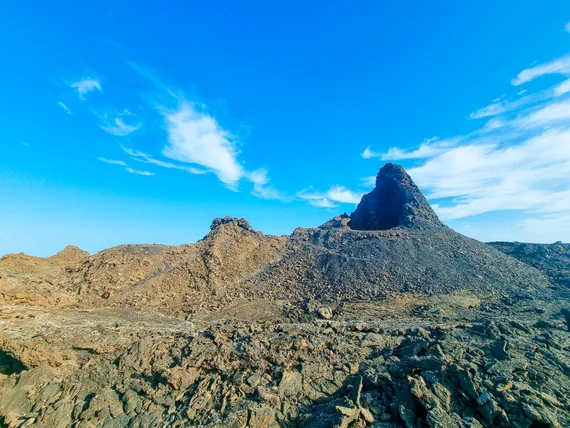 Pointed volcanic rock formation in barren lava field