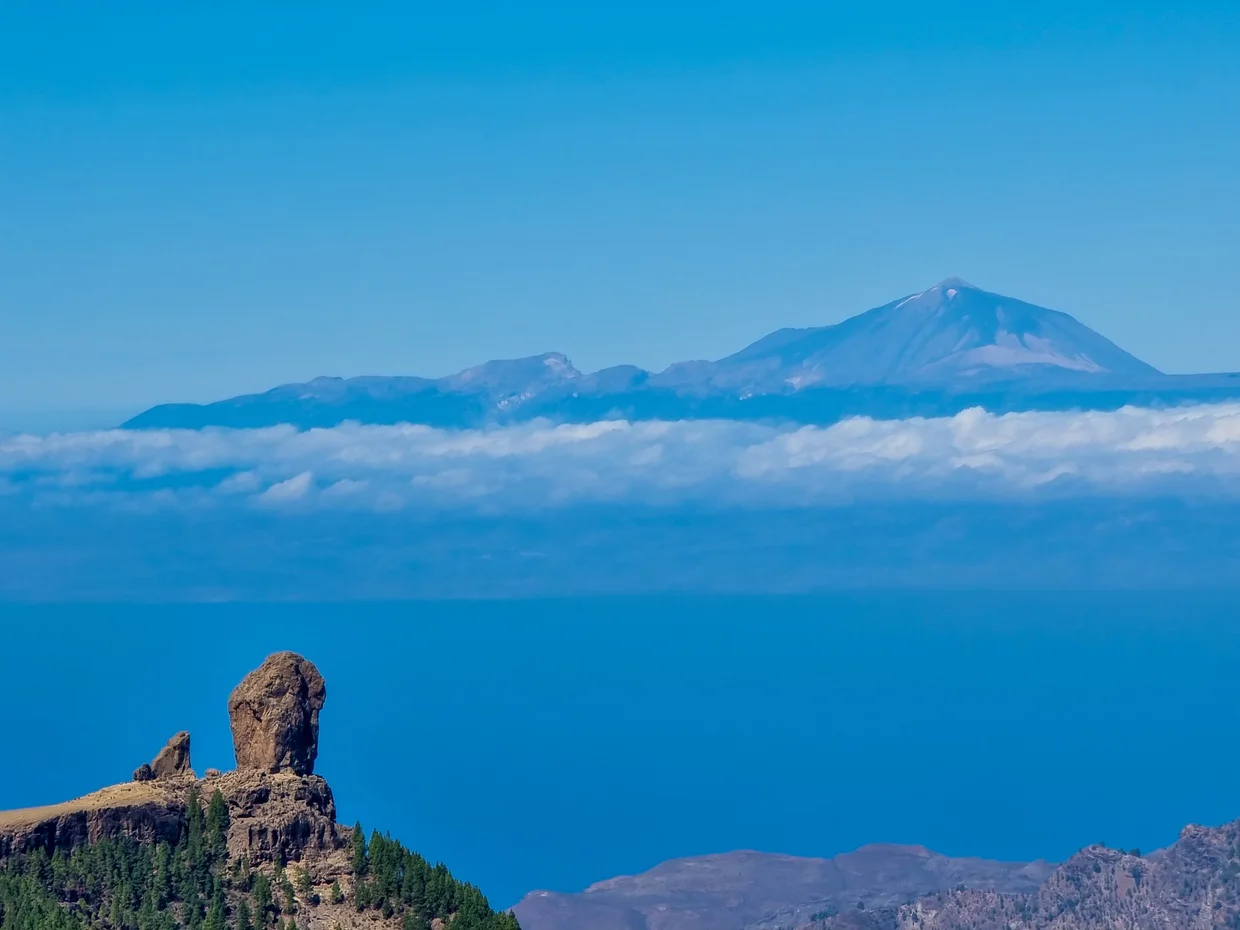 Roque Nublo with Teide floating above clouds on the horizon, seen from Gran Canaria