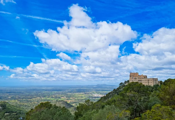 Hilltop monastery overlooking vast agricultural plain