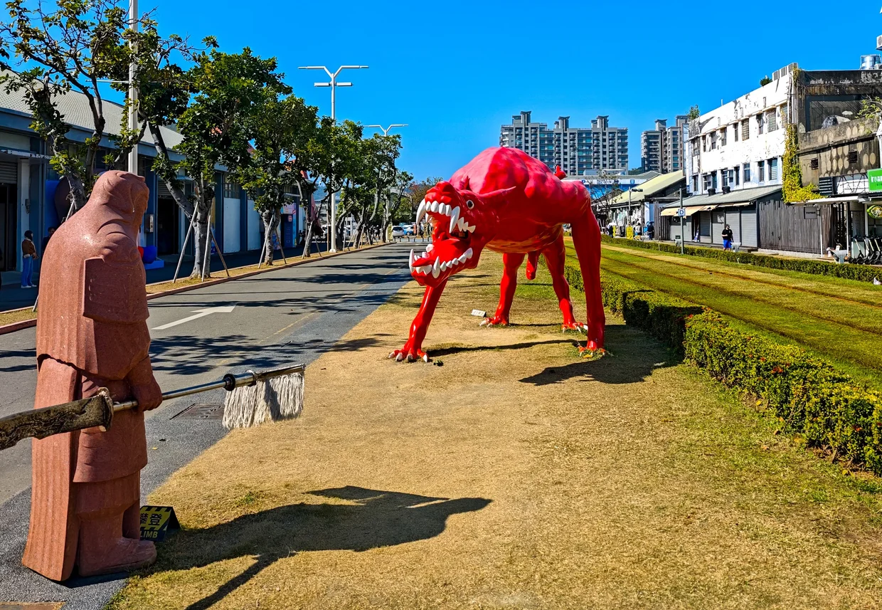 Public art at Pier-2: a giant red monster meets a small visitor